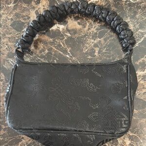 Black Shoulder Bag with Unique Handle and Textured Fabric
